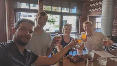 The BLISS team enjoys a beer out at a local pub with another participant from a NOAA partner office.